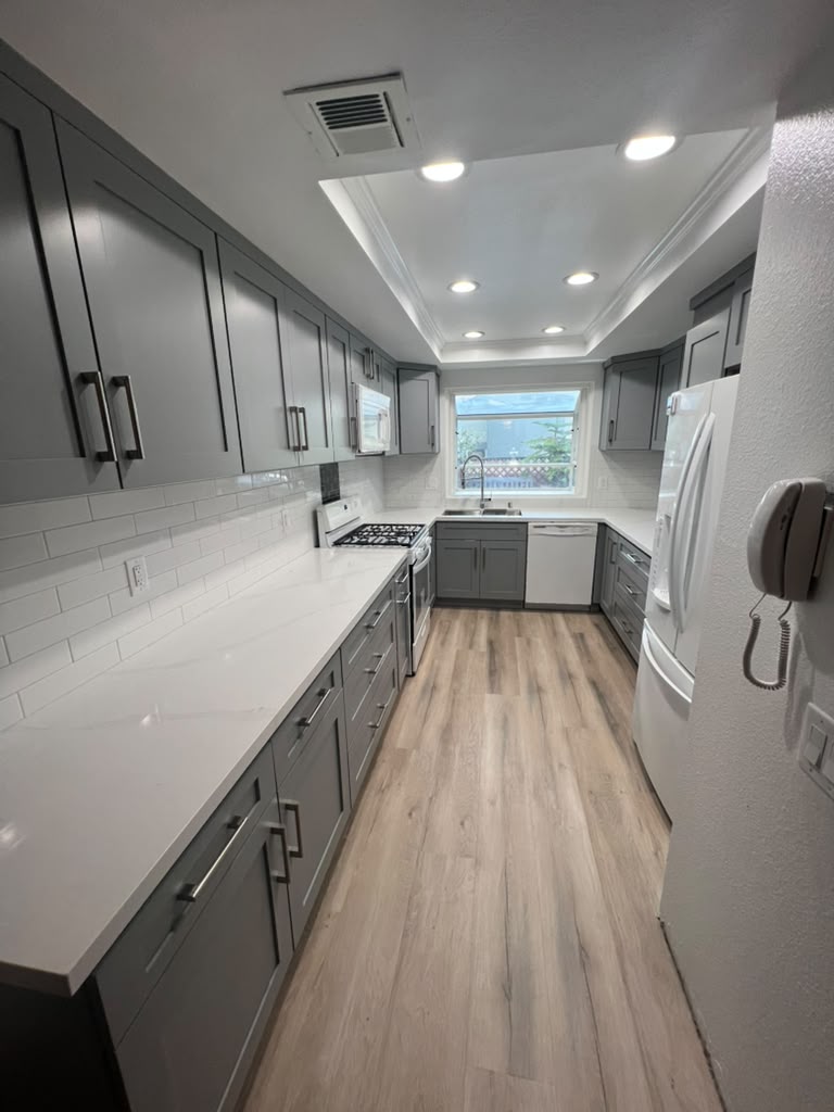 Finished Azusa kitchen with gray shaker cabinets and quartz counters